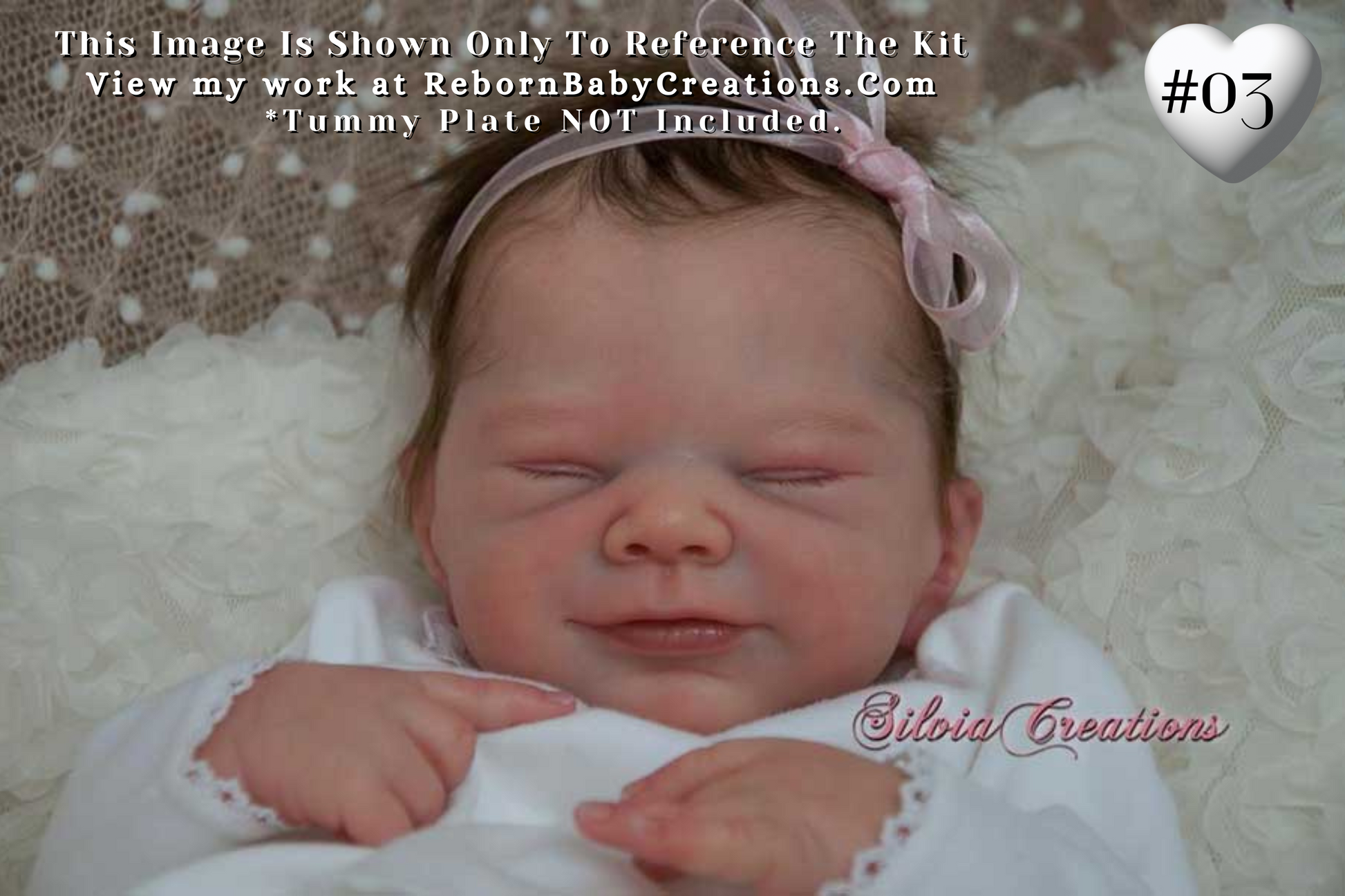 a baby with a pink bow laying on top of a white blanket