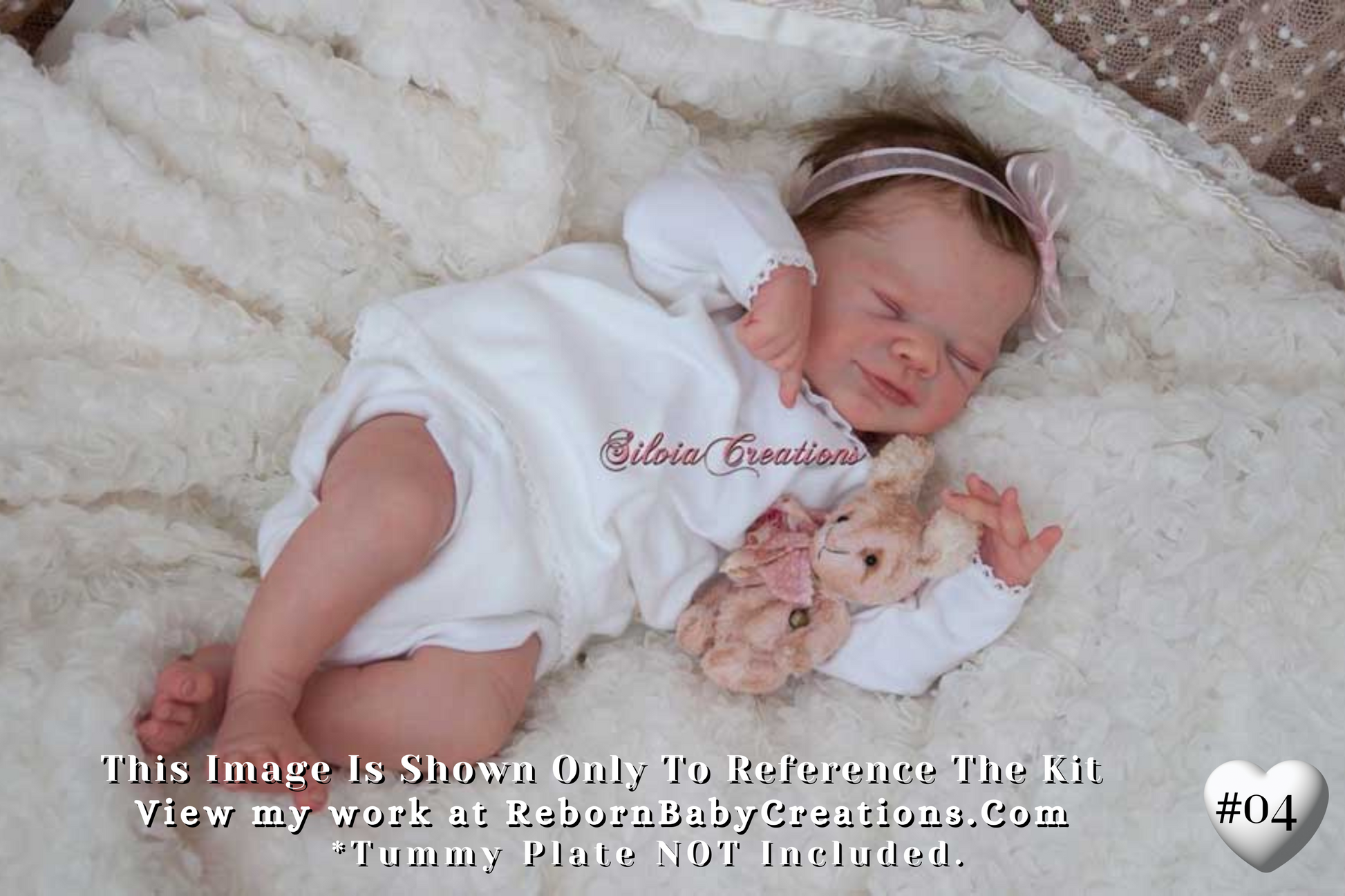 a baby laying on a blanket with a teddy bear