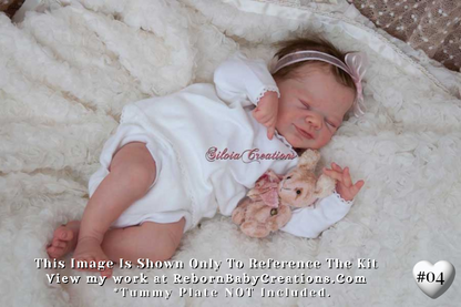 a baby laying on a blanket with a teddy bear