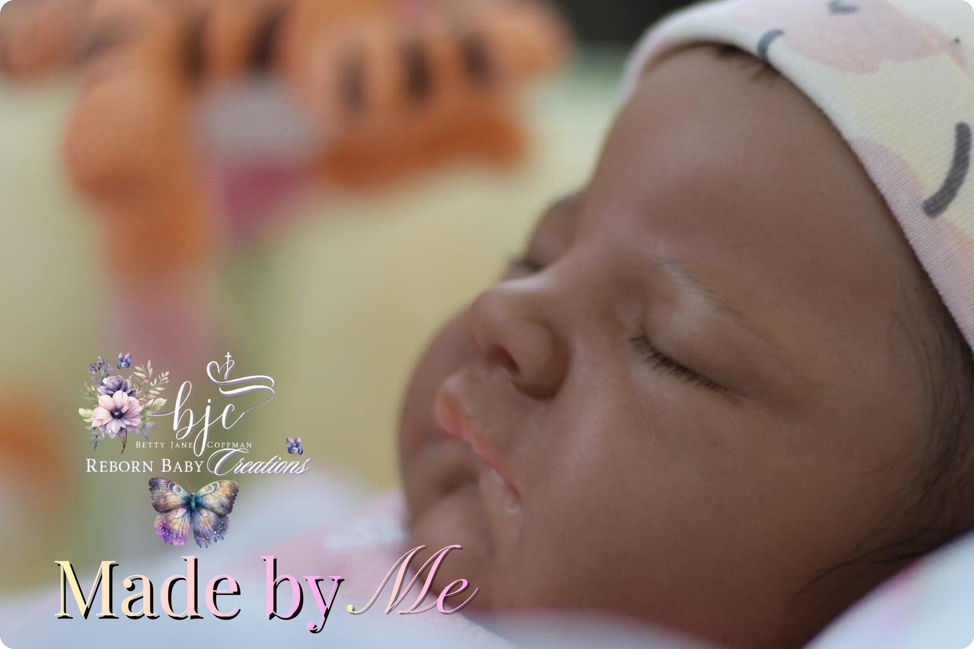 A close-up of a sleeping baby doll with a floral patterned hat, accompanied by the text "Made by Me" and the logo for "BPC BEEF REBORN BABY CREATIONS".