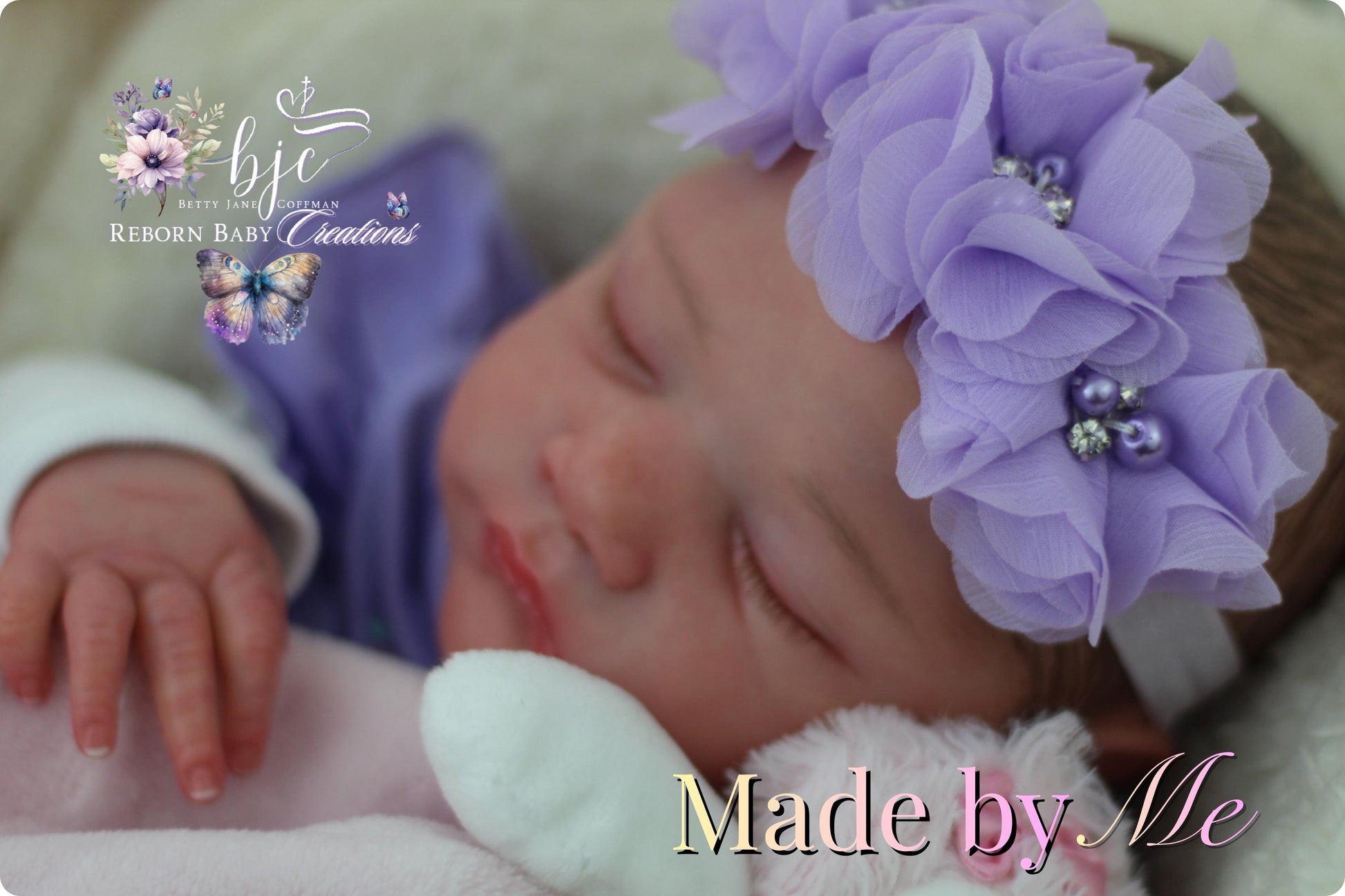 A newborn baby girl wearing a purple flower headband and sleeping peacefully, with the text "Made by Me" and "BJC REBORN BABY CREATIONS" displayed in the image.