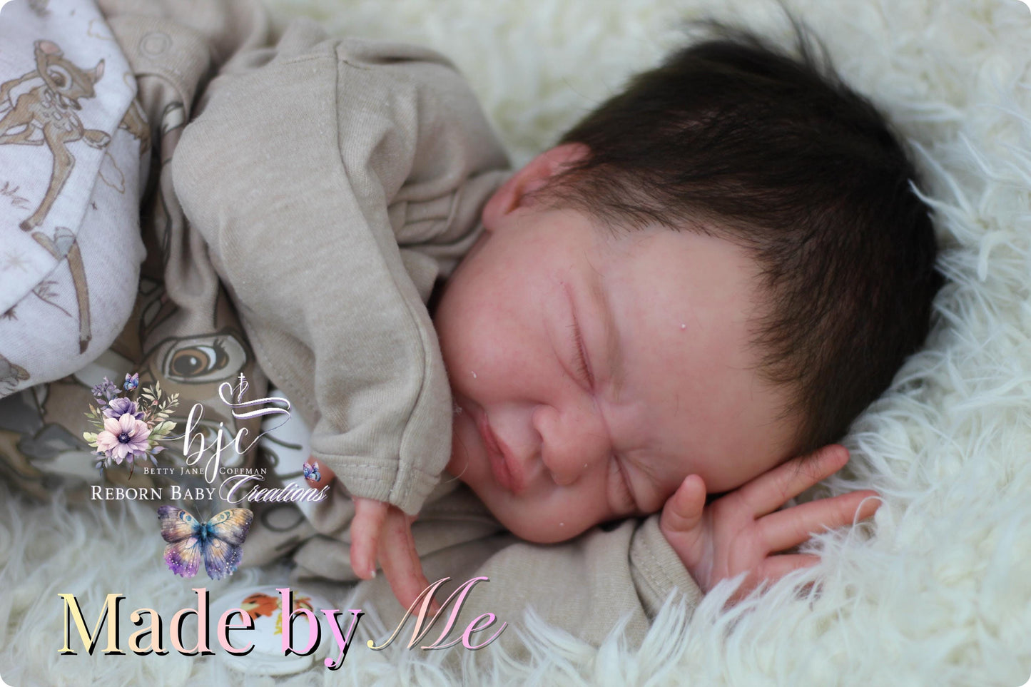 A newborn baby is peacefully sleeping, swaddled in a beige onesie, with a soft white blanket and a floral patterned blanket nearby.