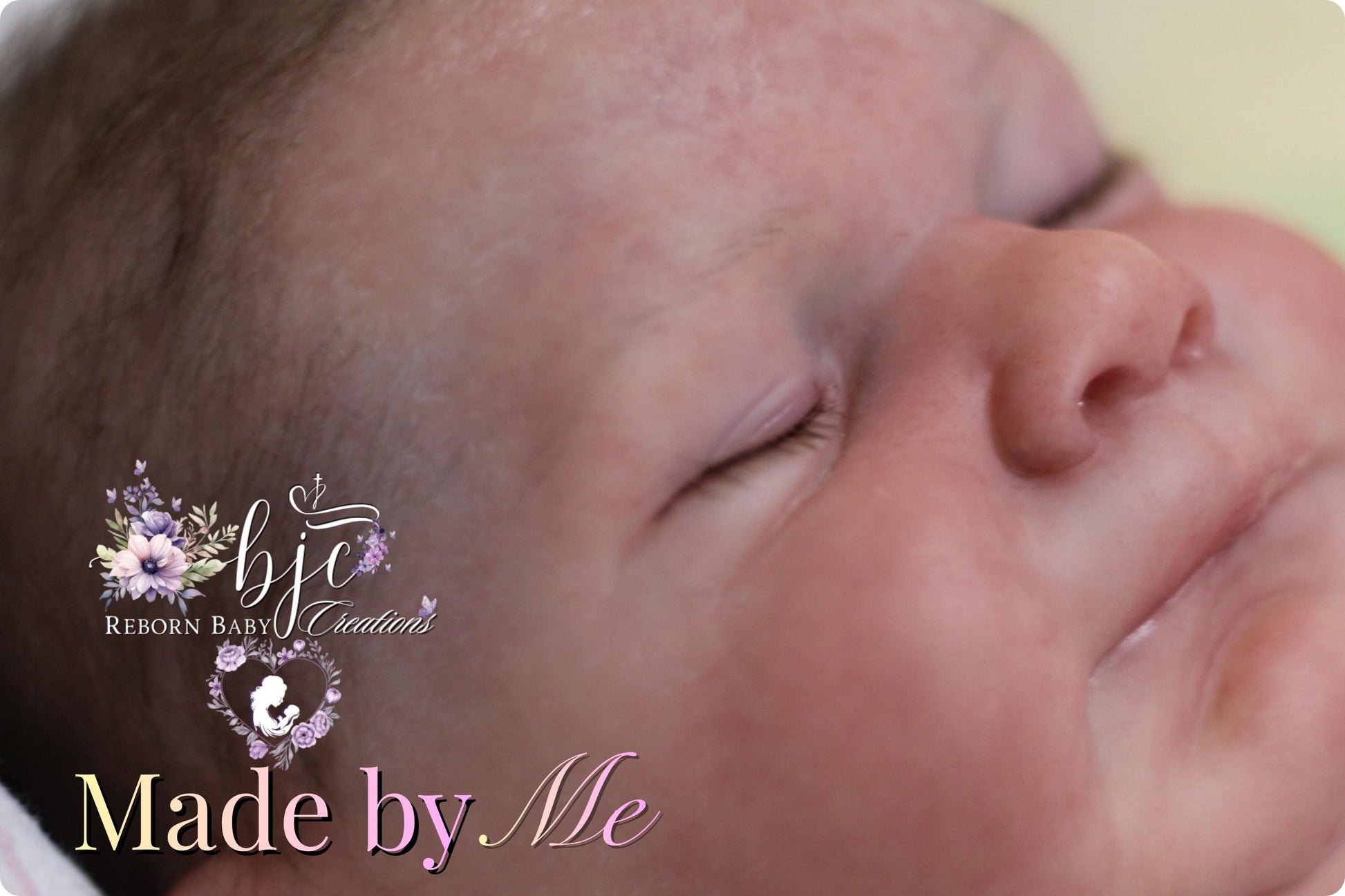 A close-up of a sleeping newborn baby's face, with the text "Made by Me" and "Reborn Baby Creations" displayed.