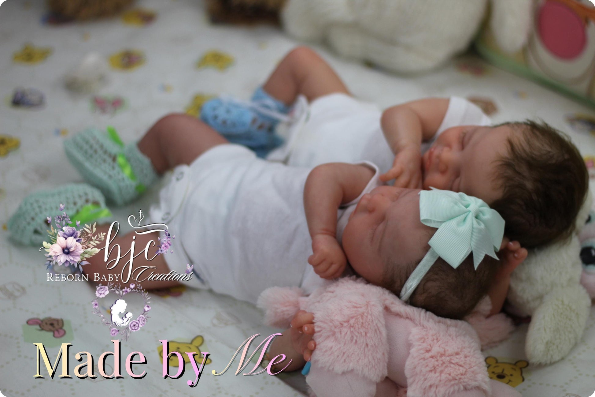 A newborn baby girl and a newborn baby boy lying together on a bed, both wearing white outfits and blue shoes.
